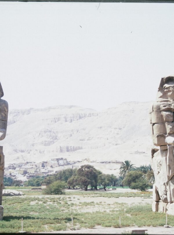 View of the Colossi of Memnon statues in Luxor, Egypt highlighting ancient Egyptian architecture.